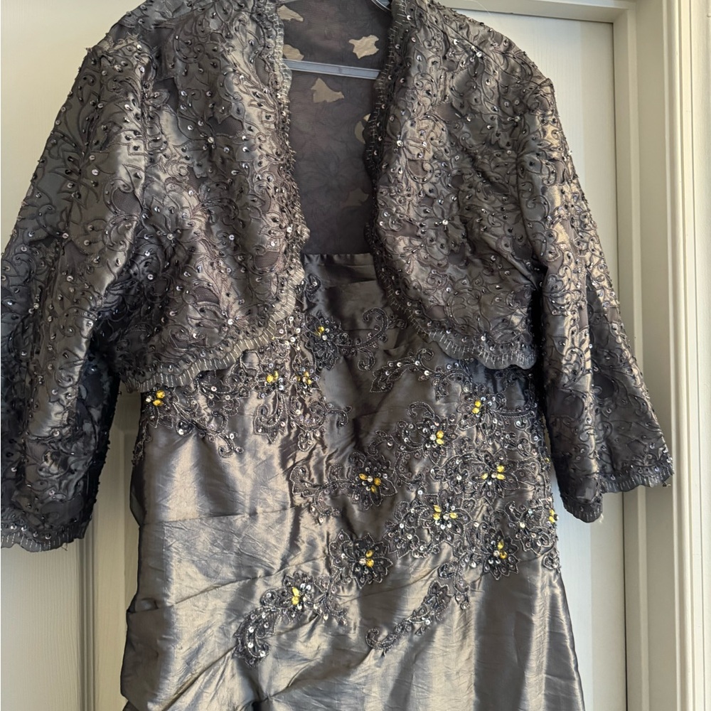 Lustrous Grace: Silver Spaghetti Strap Gown with Elegant Lace-Accented Jacket